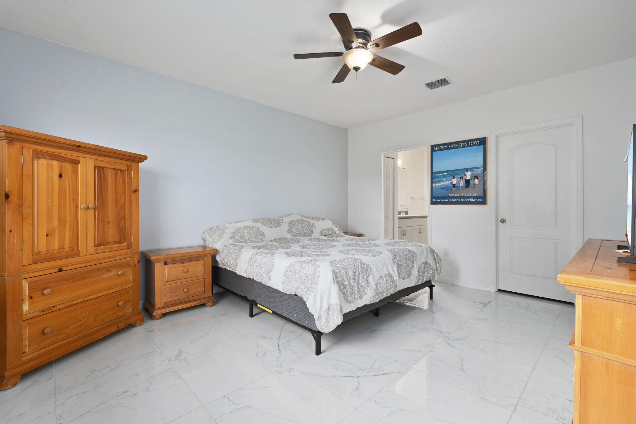 1414 Southwest Crest Avenue Port St. Lucie, FL 34953 - Photo 14 of 41 a bedroom with a bed and a cabinets