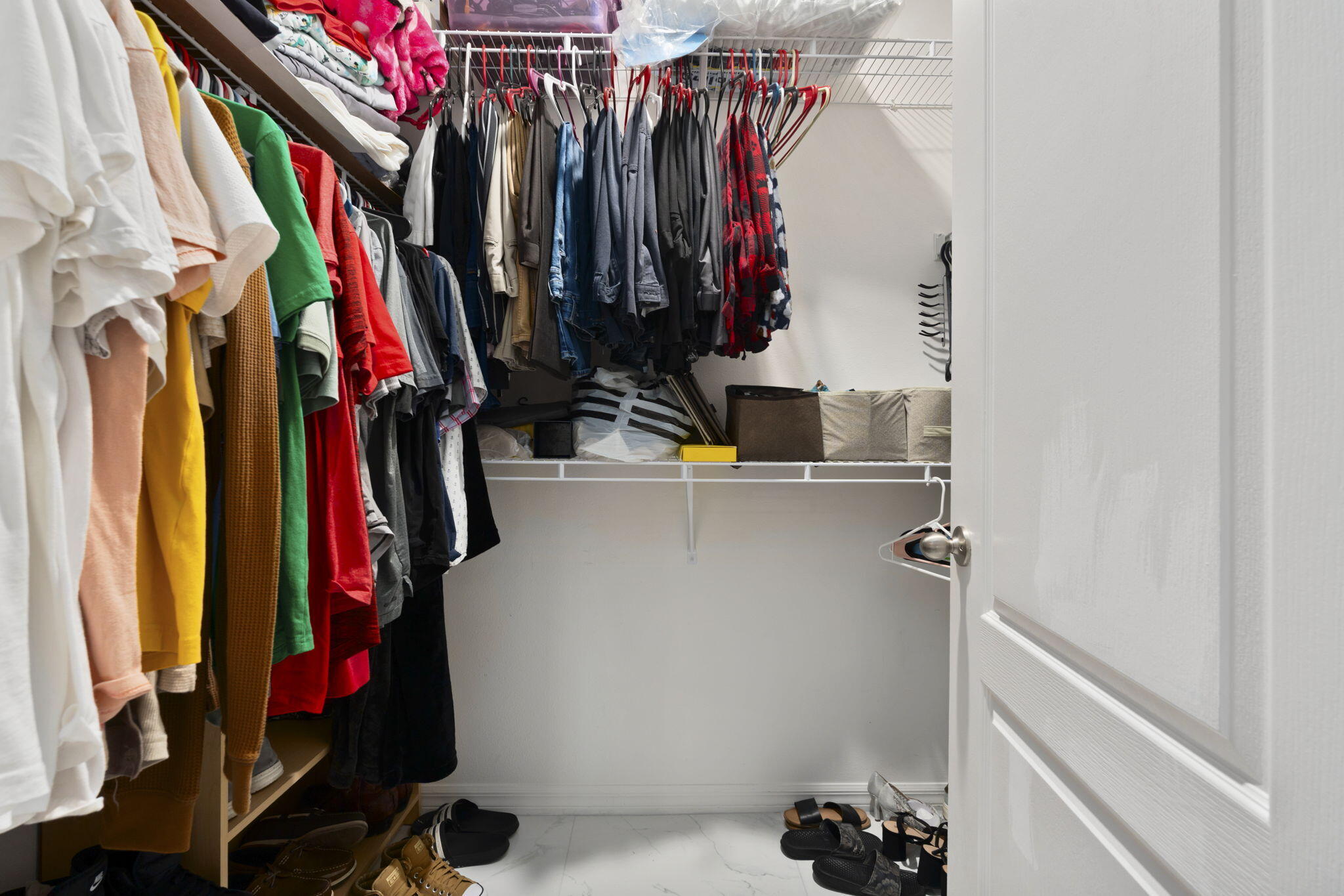 1414 Southwest Crest Avenue Port St. Lucie, FL 34953 - Photo 19 of 41 a view of walk in closet with clothes