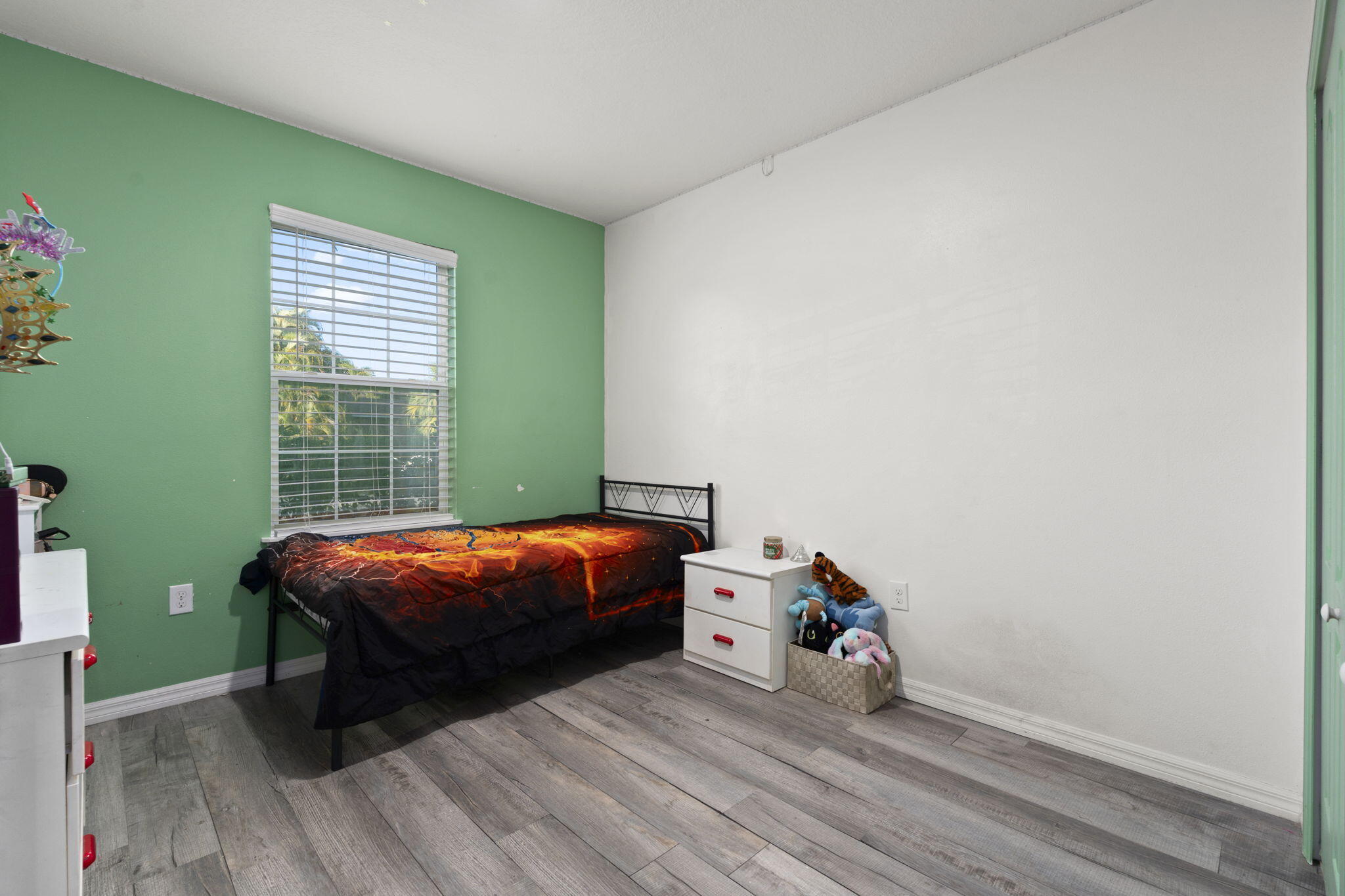 1414 Southwest Crest Avenue Port St. Lucie, FL 34953 - Photo 21 of 41 a bed room with a bed and a window