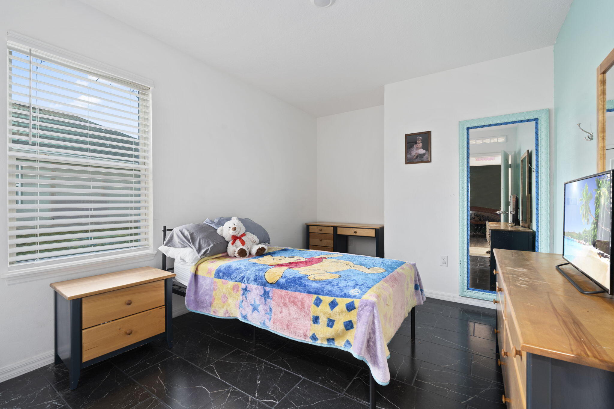 1414 Southwest Crest Avenue Port St. Lucie, FL 34953 - Photo 23 of 41 a bedroom with a bed and a dresser in it