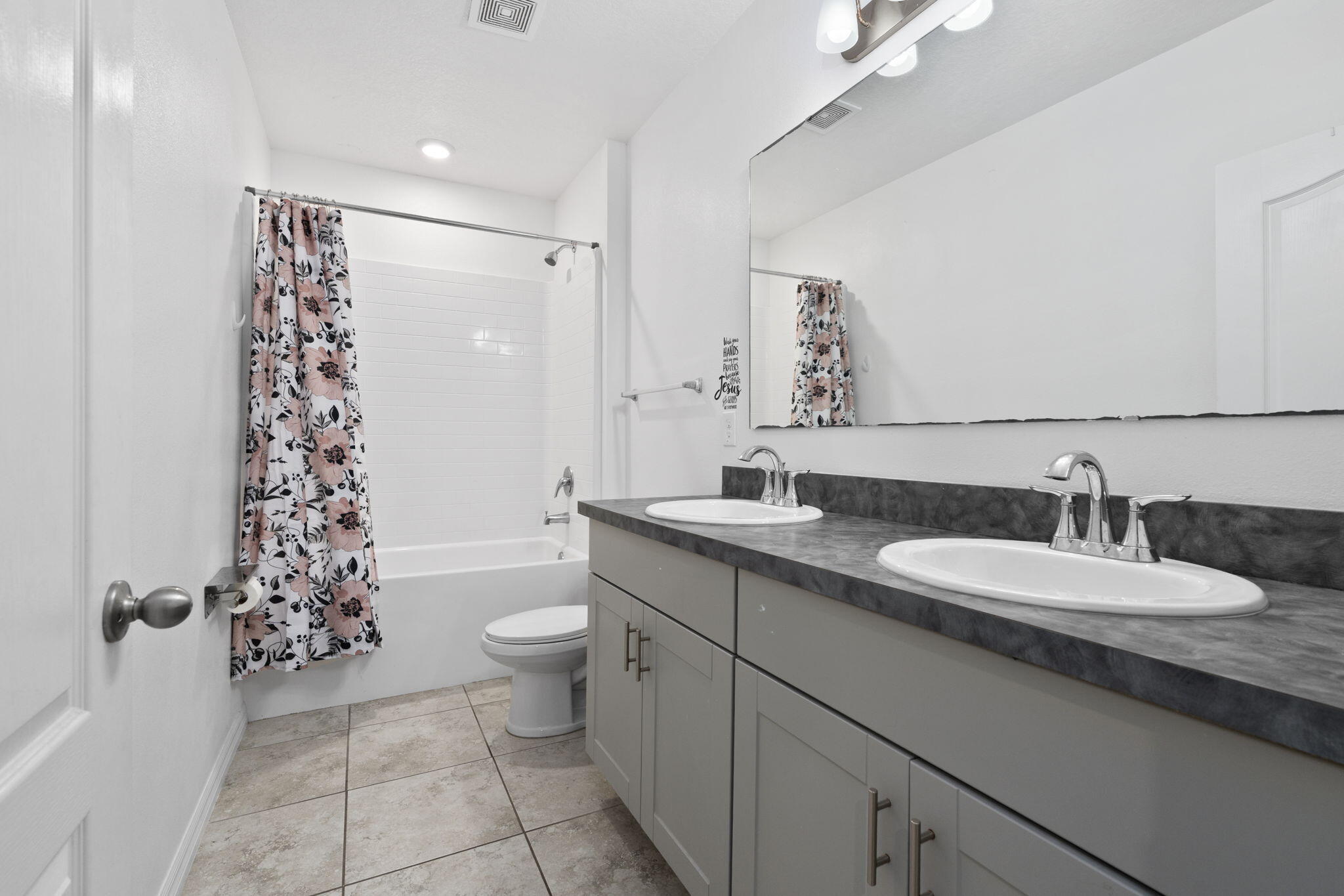 1414 Southwest Crest Avenue Port St. Lucie, FL 34953 - Photo 24 of 41 a bathroom with a double vanity sink toilet mirror and shower