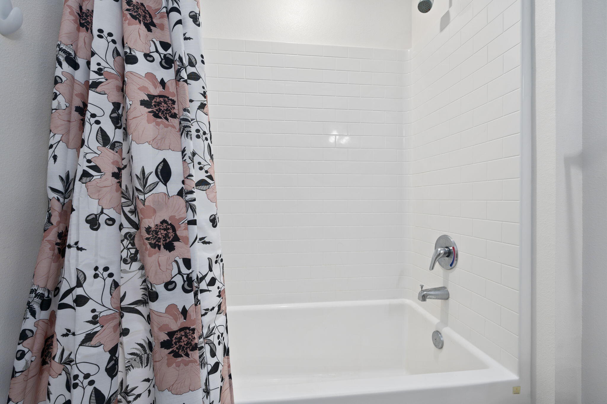 1414 Southwest Crest Avenue Port St. Lucie, FL 34953 - Photo 25 of 41 a bathroom with a bathtub and a shower curtain