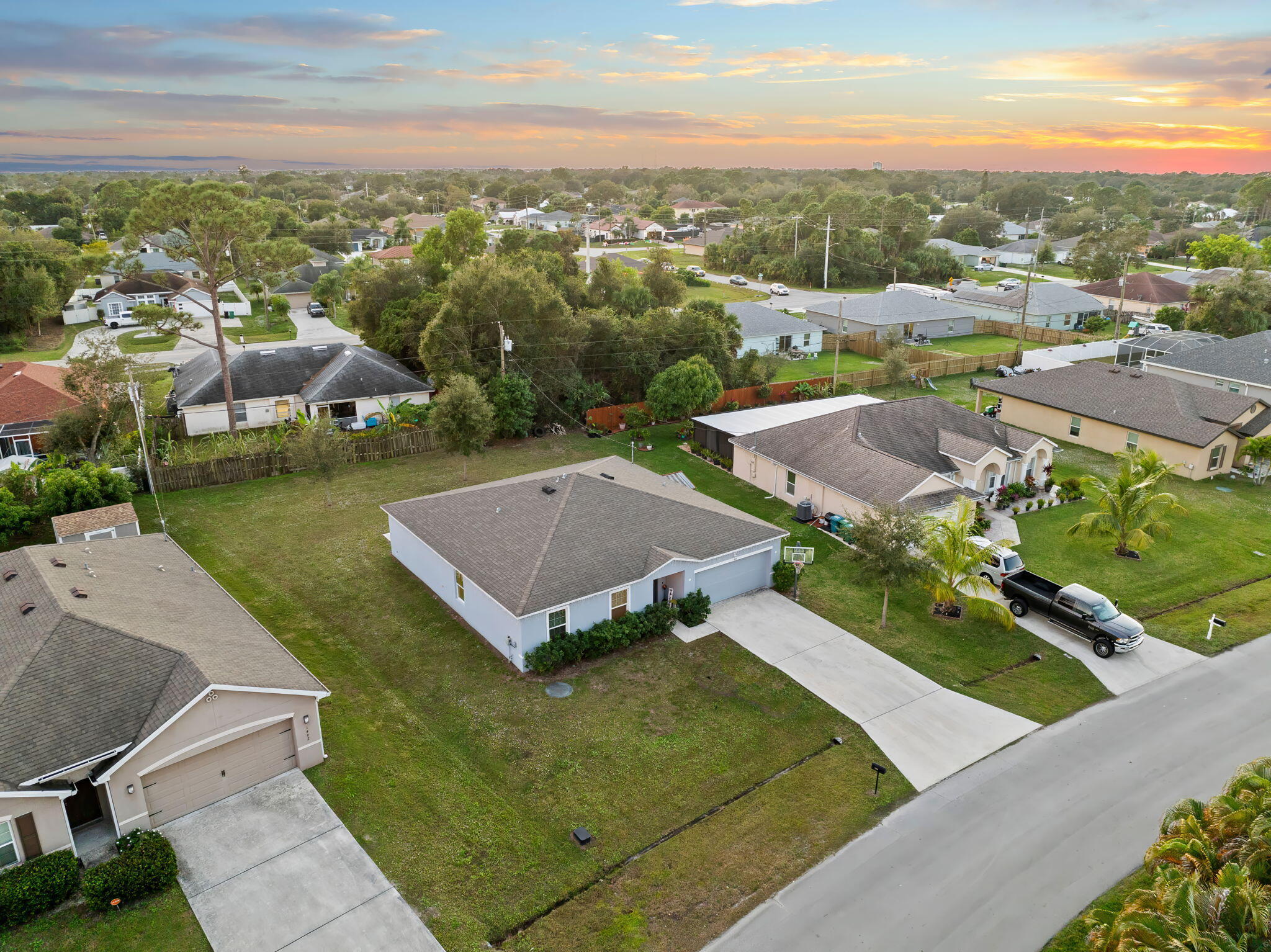 1414 Southwest Crest Avenue Port St. Lucie, FL 34953 - Photo 40 of 41 an aerial view of multiple houses with a yard