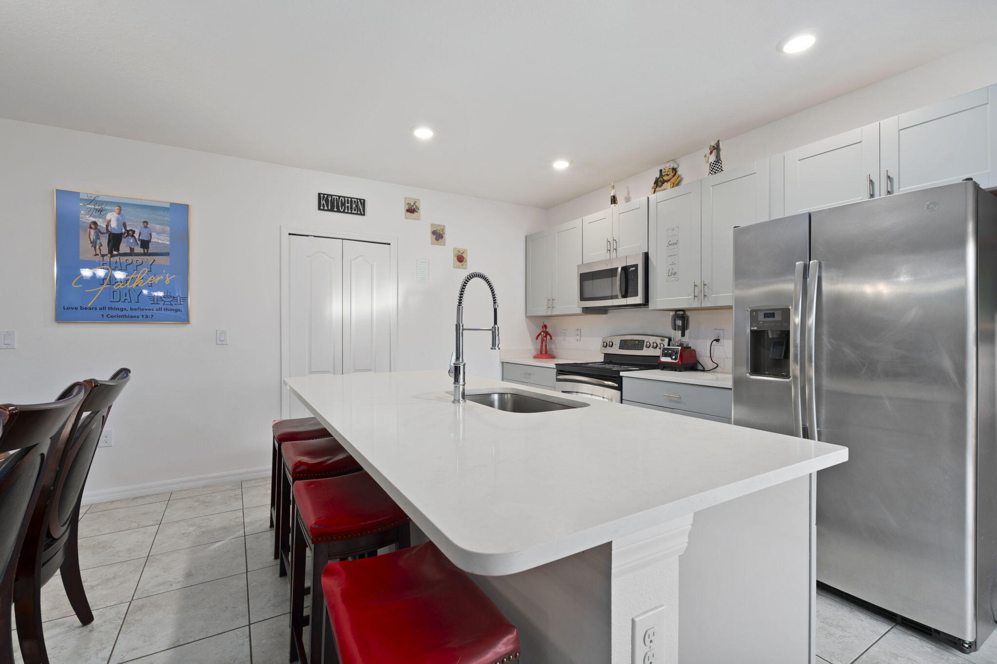 1414 Southwest Crest Avenue Port St. Lucie, FL 34953 - Photo 6 of 41 a kitchen with kitchen island a sink stove and refrigerator