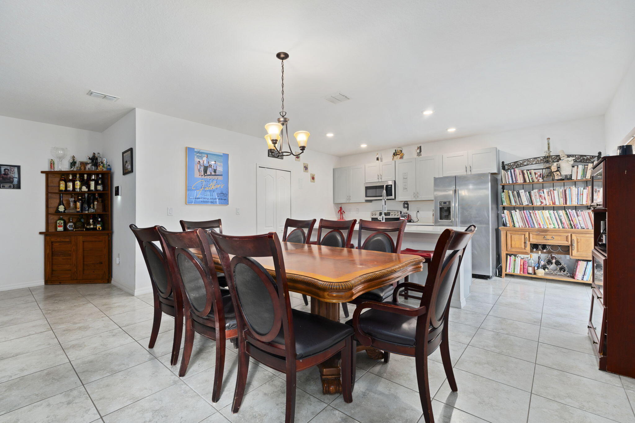 1414 Southwest Crest Avenue Port St. Lucie, FL 34953 - Photo 8 of 41 a view of a dining room and livingroom with furniture