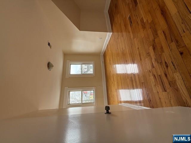 219 Renner Avenue Newark, NJ 07112 - Photo 13 of 22 a view of empty room with wooden floor and fan