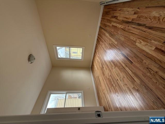 219 Renner Avenue Newark, NJ 07112 - Photo 8 of 22 a view of an empty room with wooden floor and a window