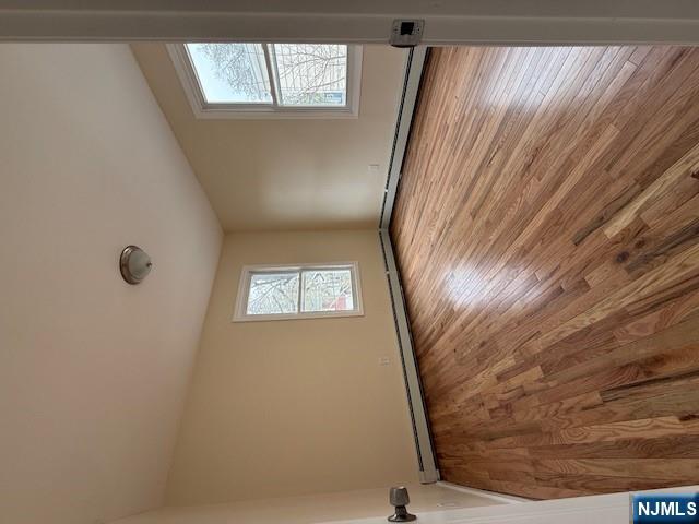 219 Renner Avenue Newark, NJ 07112 - Photo 9 of 22 an empty room with wooden floor and windows