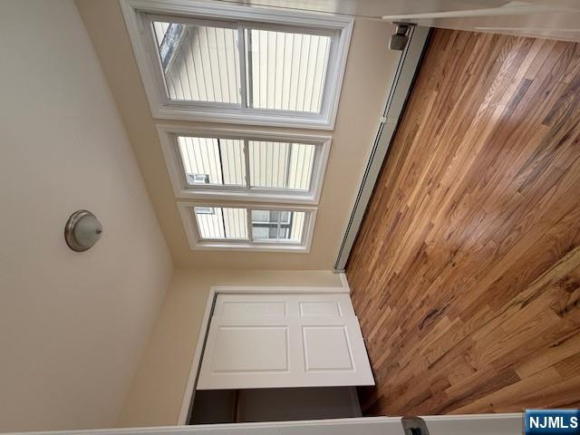 219 Renner Avenue Newark, NJ 07112 - Photo 10 of 22 a view of an empty room with wooden floor and a window