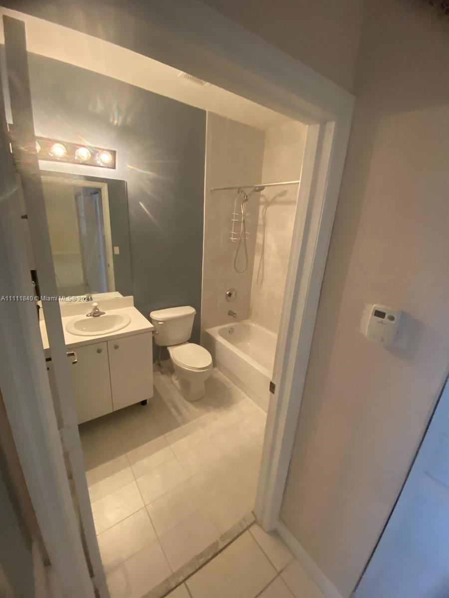 Oasis Homestead, FL 33033 - Photo 11 of 21 a bathroom with a sink a toilet and shower