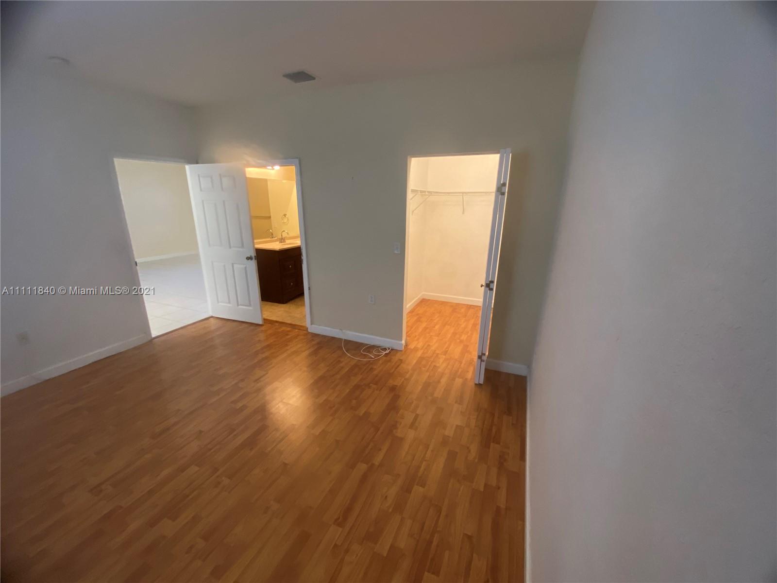 Oasis Homestead, FL 33033 - Photo 6 of 21 a view of a room with wooden floor and brick walls