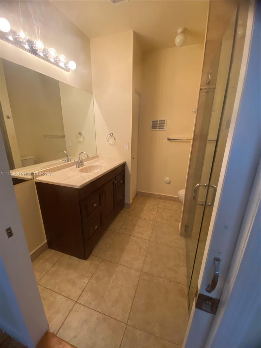 Oasis Homestead, FL 33033 - Photo 8 of 21 a bathroom with a sink mirror and vanity
