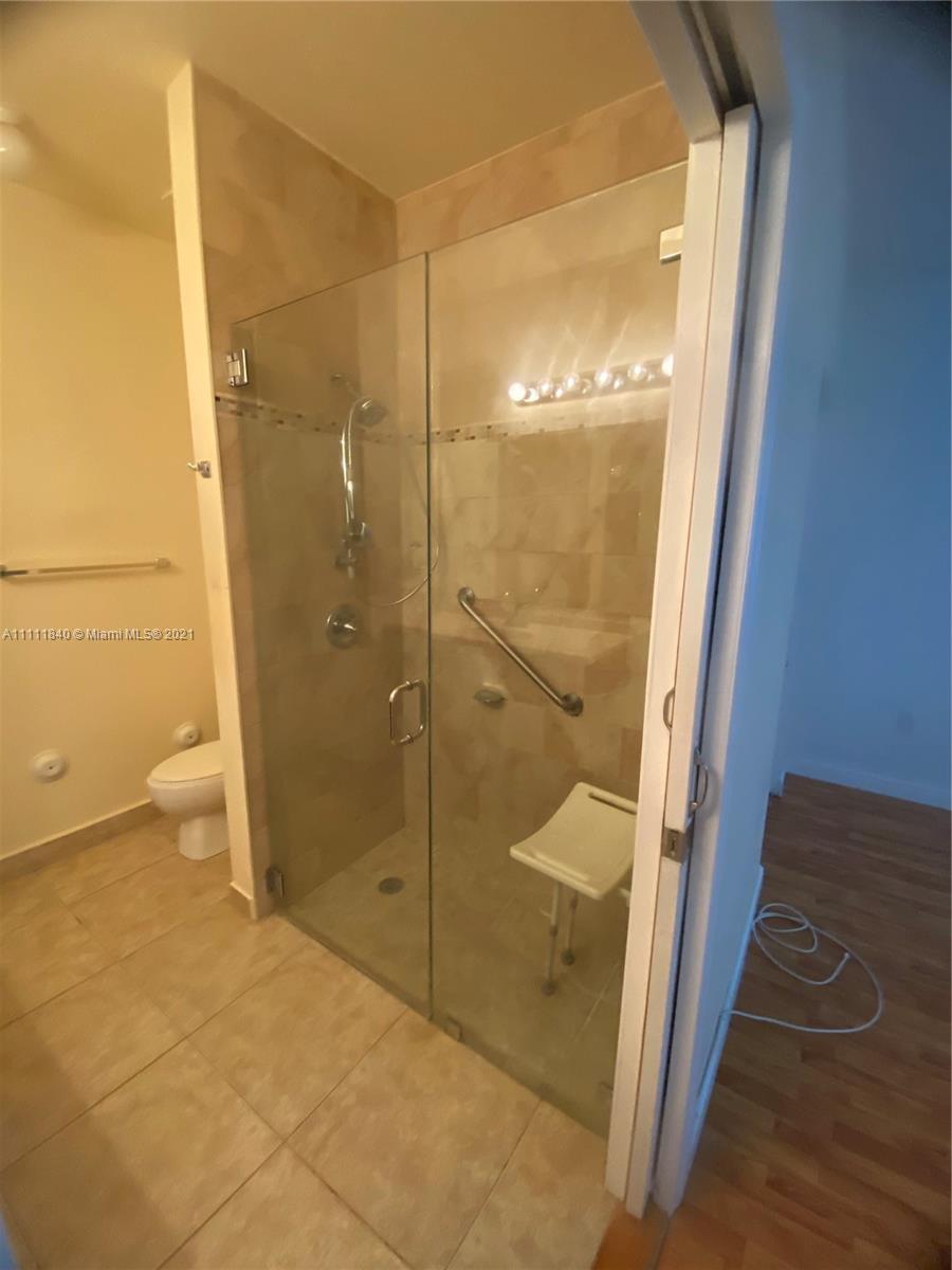 Oasis Homestead, FL 33033 - Photo 9 of 21 a bathroom with a glass shower door