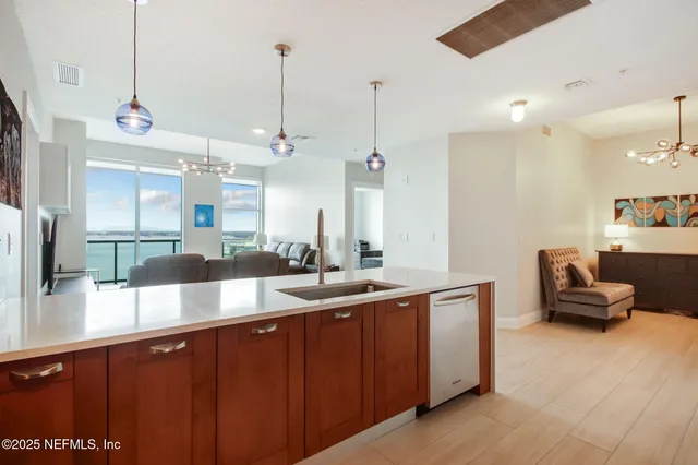 a spacious bedroom with a bed and a chandelier