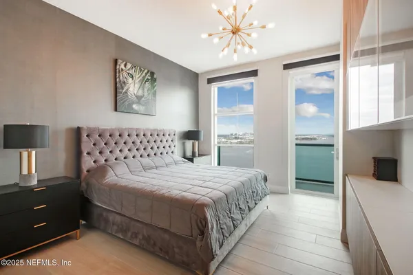 a bedroom with a bed and a chandelier
