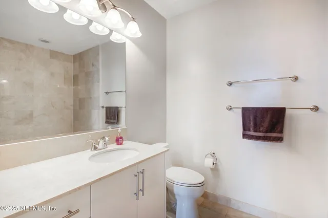 a white bath tub sitting next to a shower