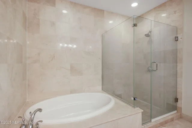 a dining room with stainless steel appliances kitchen island granite countertop a refrigerator and cabinets