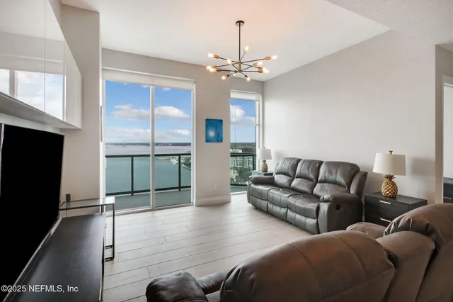 a living room with furniture a ceiling fan and a rug