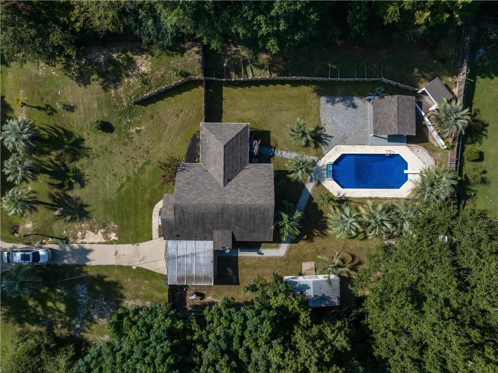 4 Ford Road Phenix City, AL 36869 - Photo 50 of 52 In-ground swimming pool with surrounding hardscaping, gravel patio area, and mature trees