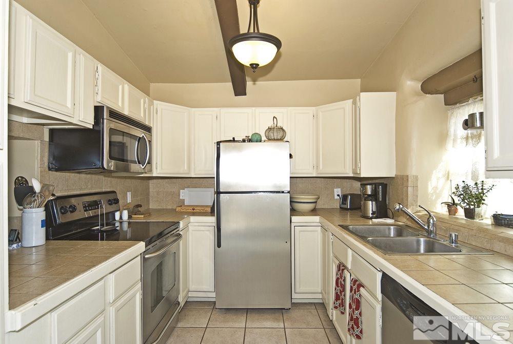 10810 Chesapeake Drive Reno, NV 89506 - Photo 11 of 22 a kitchen with a sink stainless steel appliances and cabinets