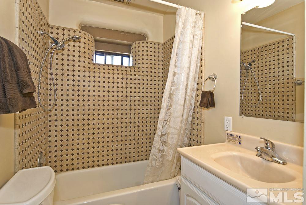10810 Chesapeake Drive Reno, NV 89506 - Photo 15 of 22 a bathroom with a sink toilet and shower