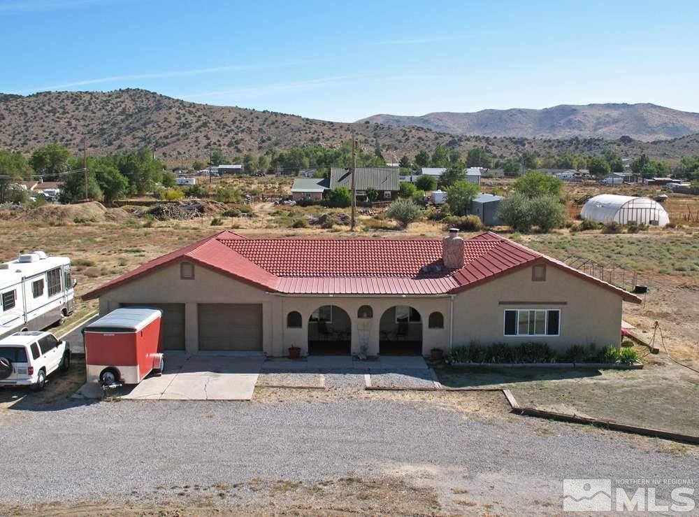 10810 Chesapeake Drive Reno, NV 89506 - Photo 3 of 22 a front view of a house with a garden and a tree