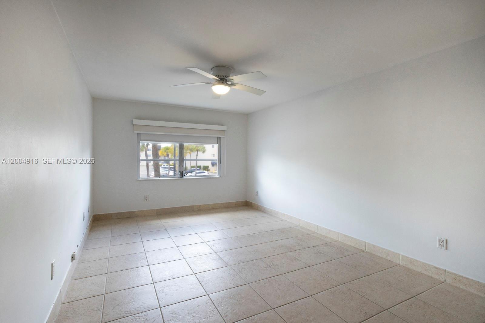 7747 Southwest 86th Street, Unit D205 Miami, FL 33143 - Photo 14 of 15 an empty room with windows and fan