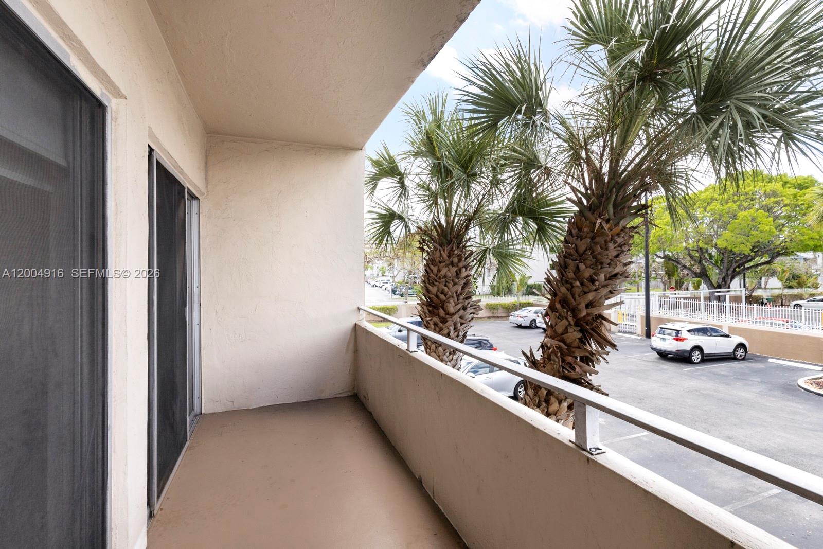 7747 Southwest 86th Street, Unit D205 Miami, FL 33143 - Photo 5 of 15 a view of swimming pool with a couches and trees