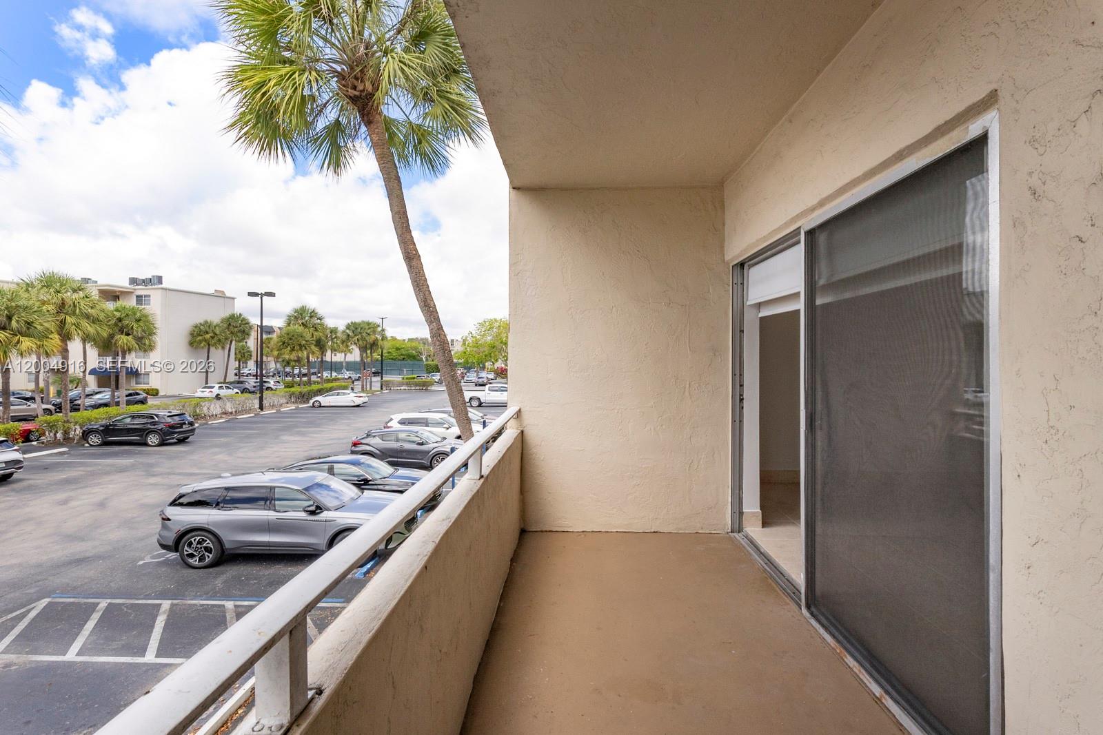 7747 Southwest 86th Street, Unit D205 Miami, FL 33143 - Photo 6 of 15 a view of swimming pool from a balcony