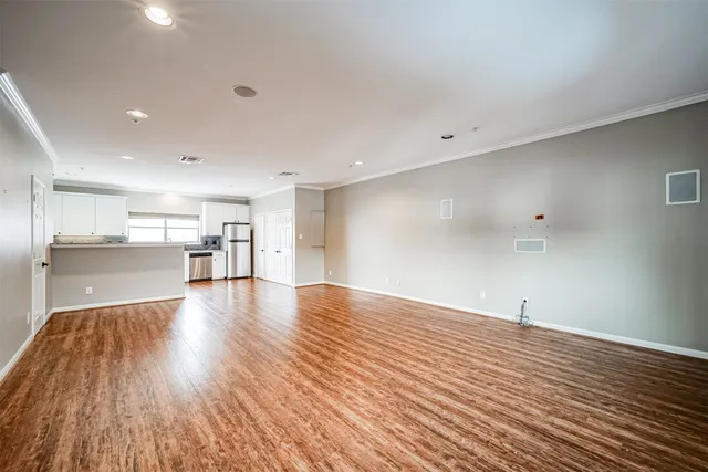 a view of a kitchen with wooden floor and a sink