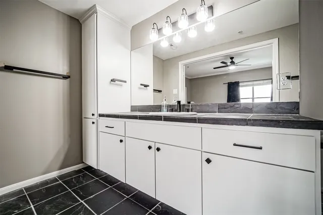a bathroom with a double vanity sink mirror and shower