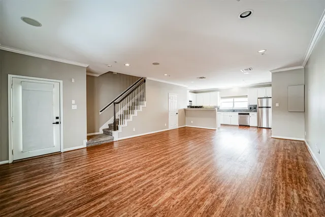 a view of empty room with wooden floor