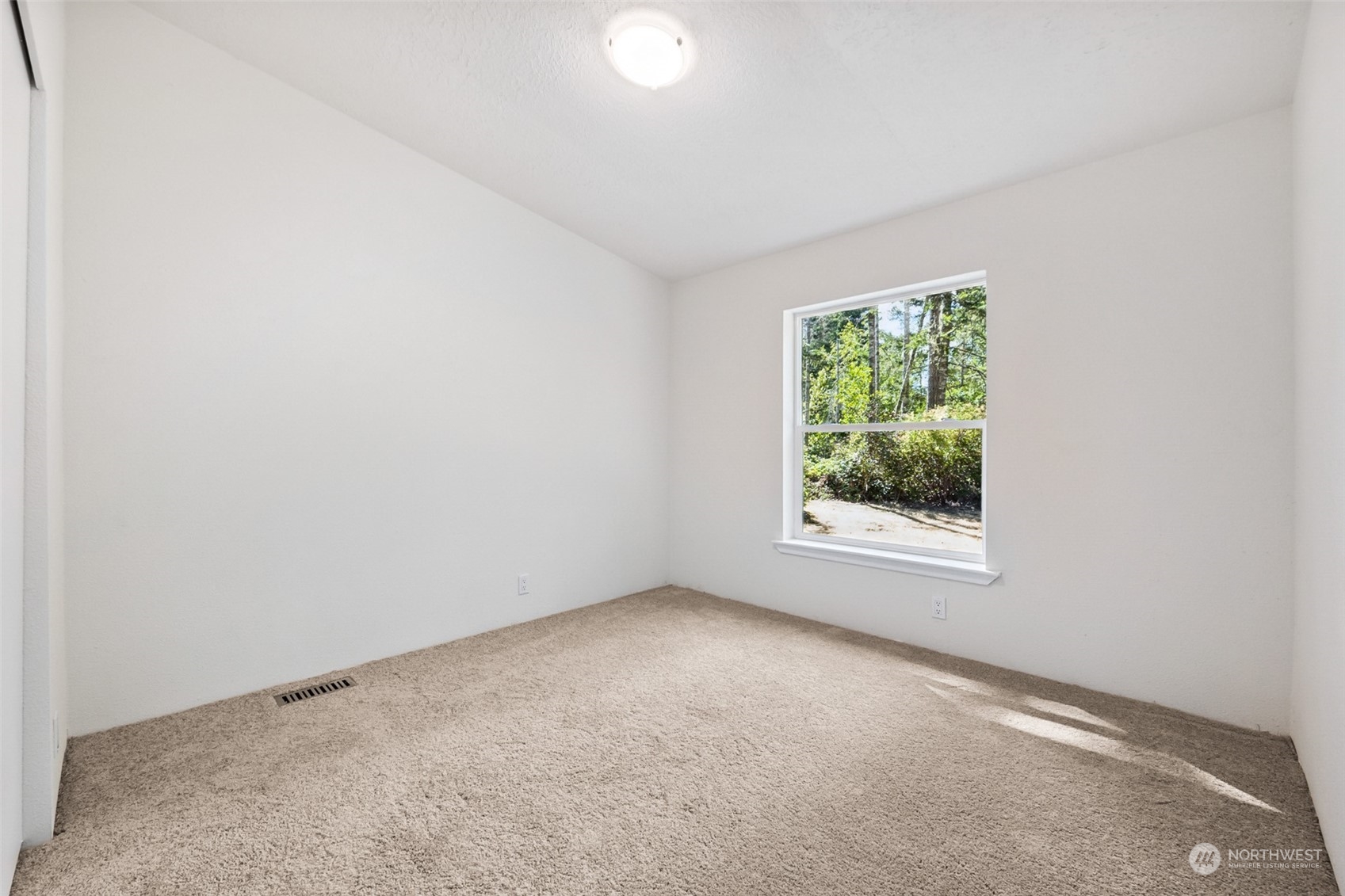 271 East Leffler Loop Road Grapeview, WA 98546 - Photo 19 of 36 an empty room with windows