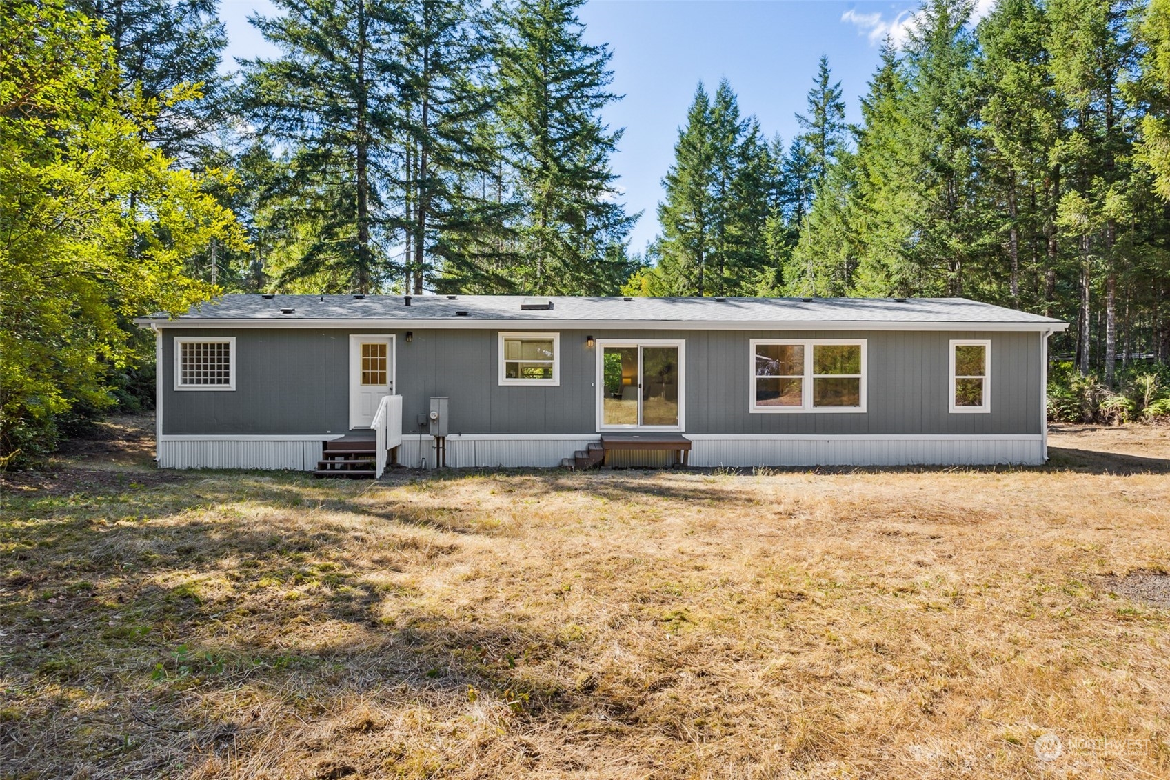 271 East Leffler Loop Road Grapeview, WA 98546 - Photo 28 of 36 front view of house with a yard