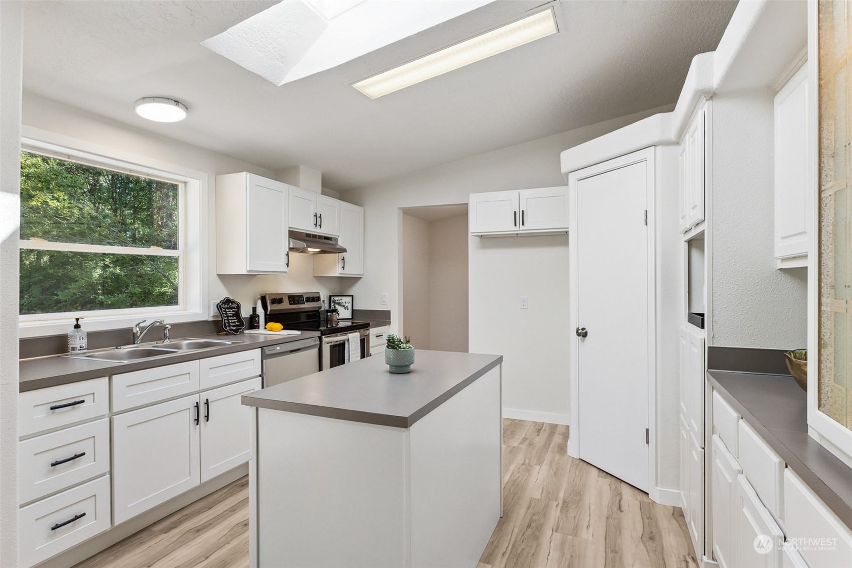 271 East Leffler Loop Road Grapeview, WA 98546 - Photo 9 of 36 a kitchen with white cabinets and window