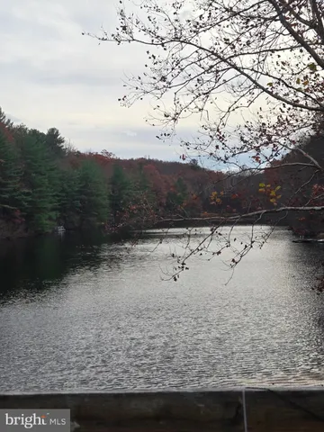 a view of a yard with wooden fence