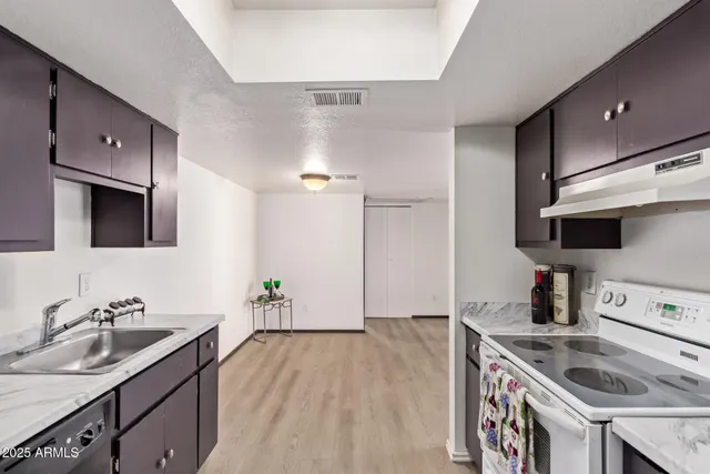 a kitchen with a sink and a stove top oven