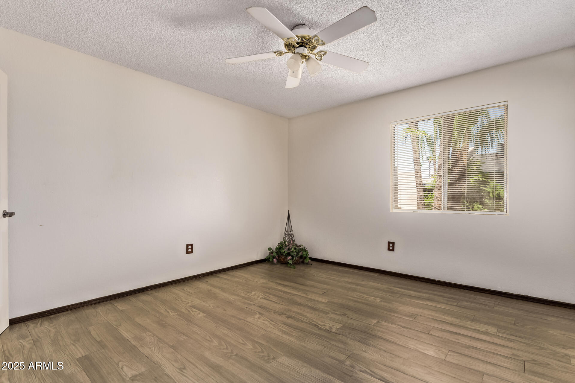 729 West Coolidge Street, Unit 211 Phoenix, AZ 85013 - Photo 12 of 21 an empty room with wooden floor and windows