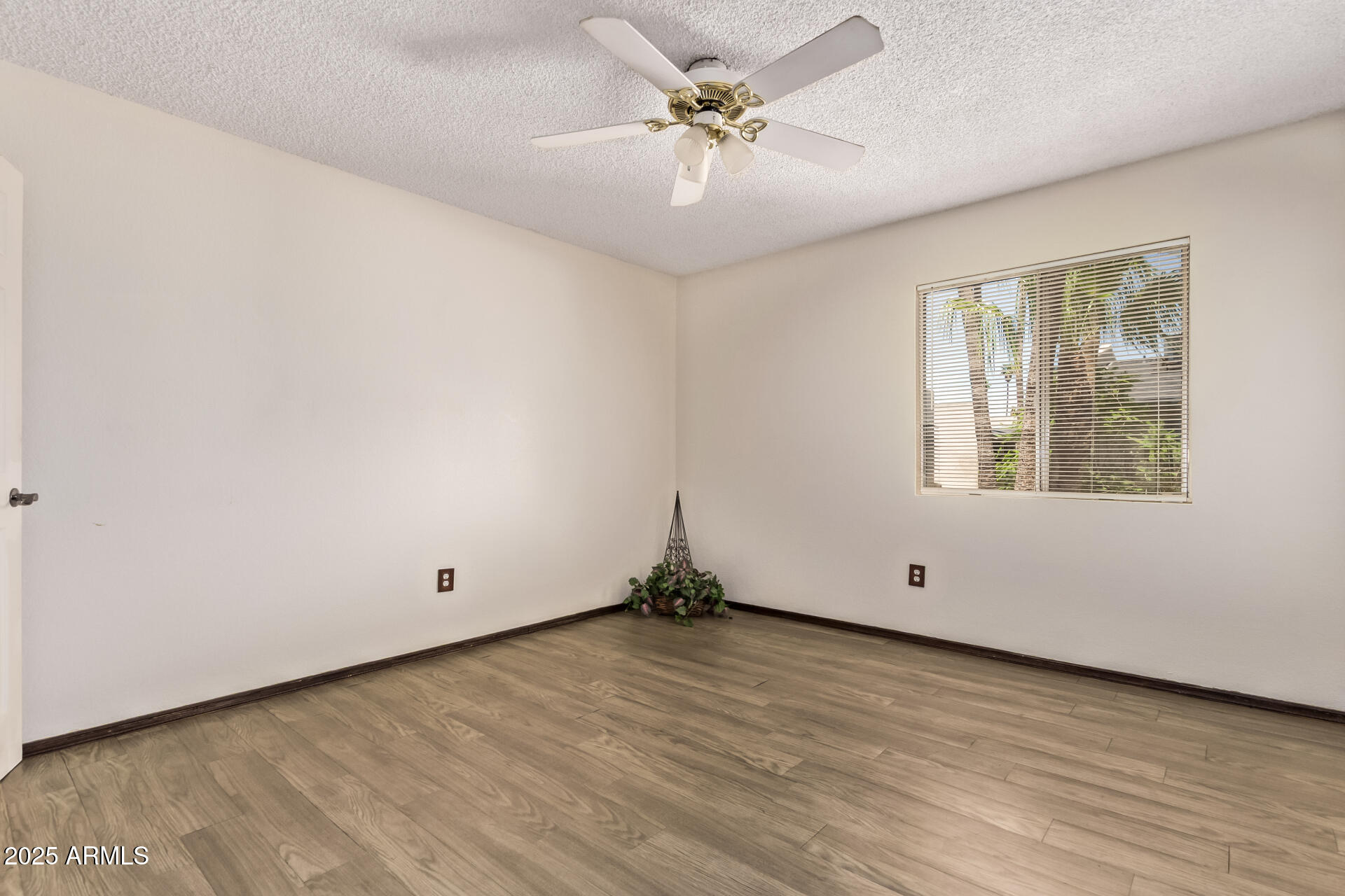 729 West Coolidge Street, Unit 211 Phoenix, AZ 85013 - Photo 13 of 21 an empty room with wooden floor and windows