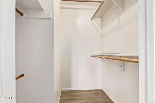 a view of walk in closet with empty racks