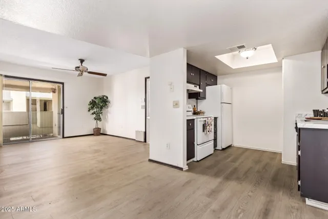 a view of a kitchen with a sink cabinets and wooden floor