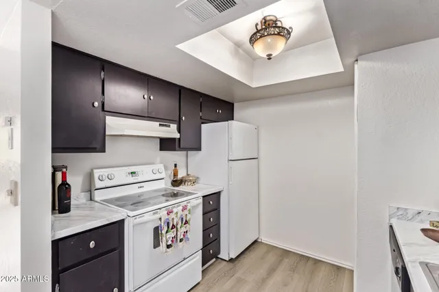 a kitchen with a refrigerator and a sink