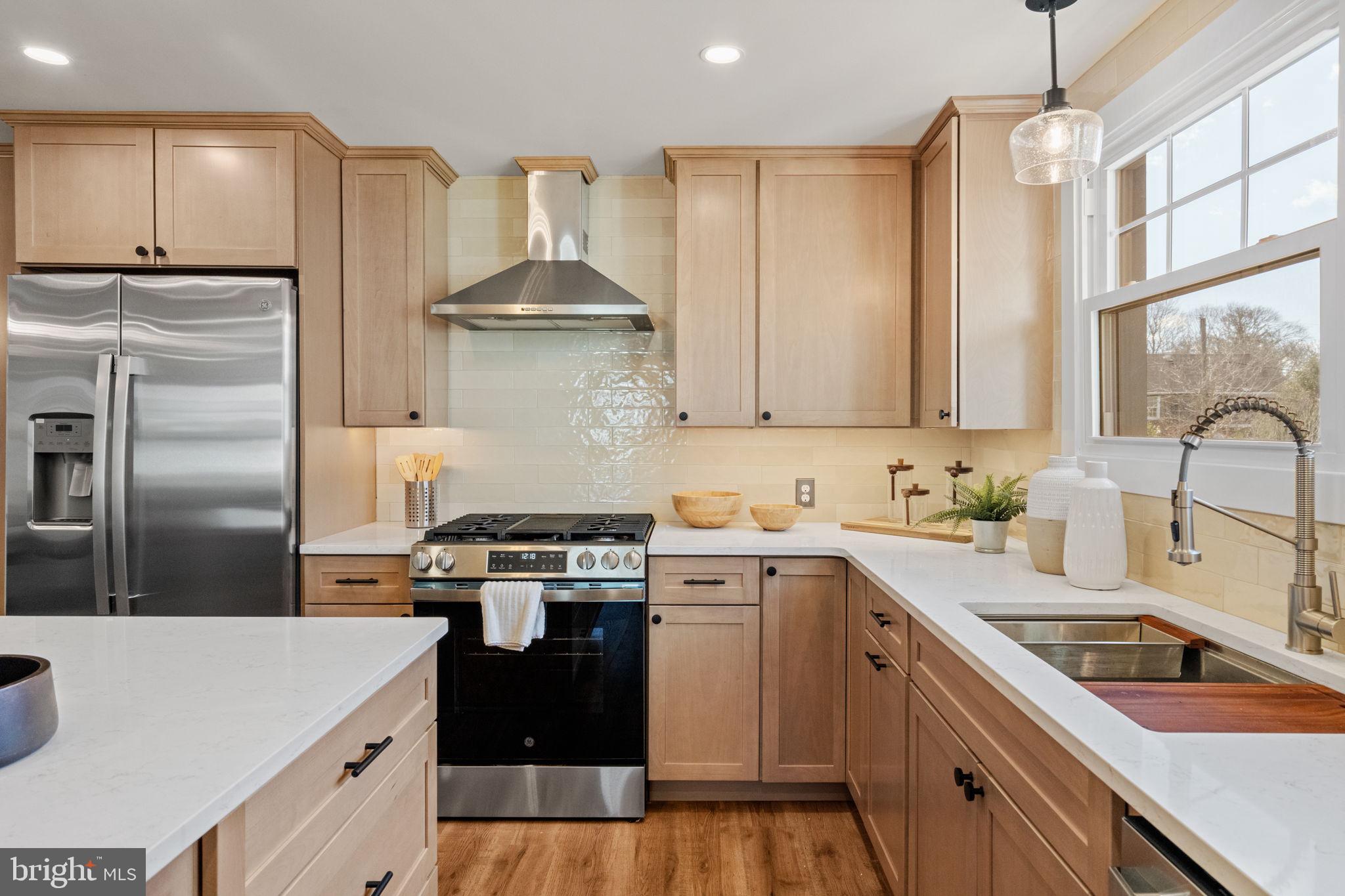 1439 Dorchester Road Havertown, PA 19083 - Photo 12 of 60 a kitchen with a sink a stove and refrigerator