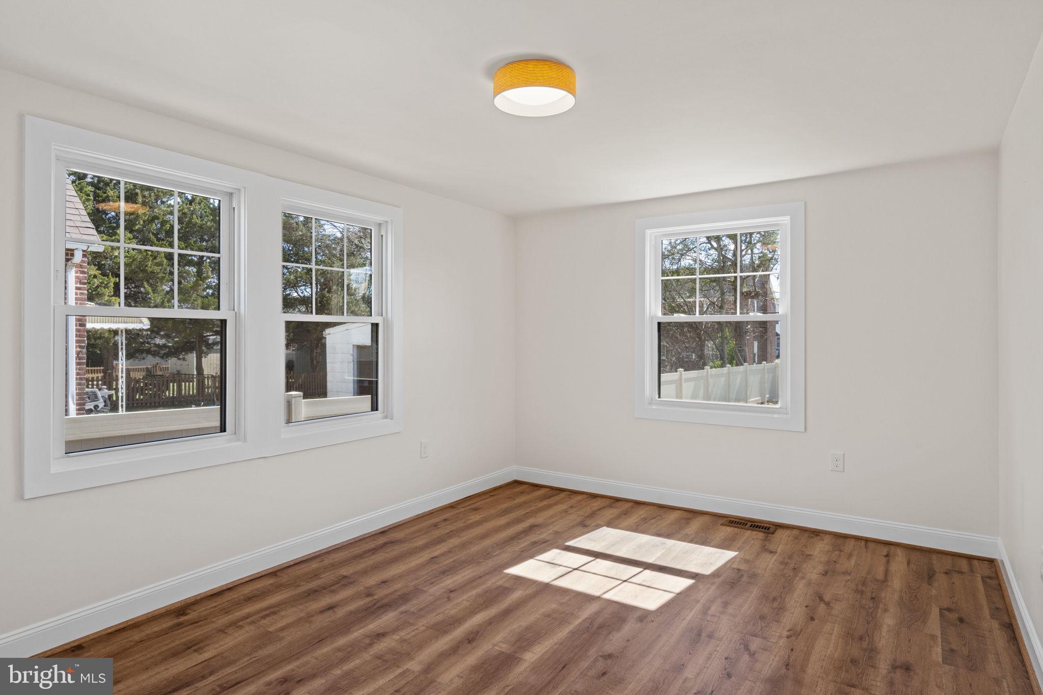 1439 Dorchester Road Havertown, PA 19083 - Photo 40 of 60 an empty room with wooden floor and windows
