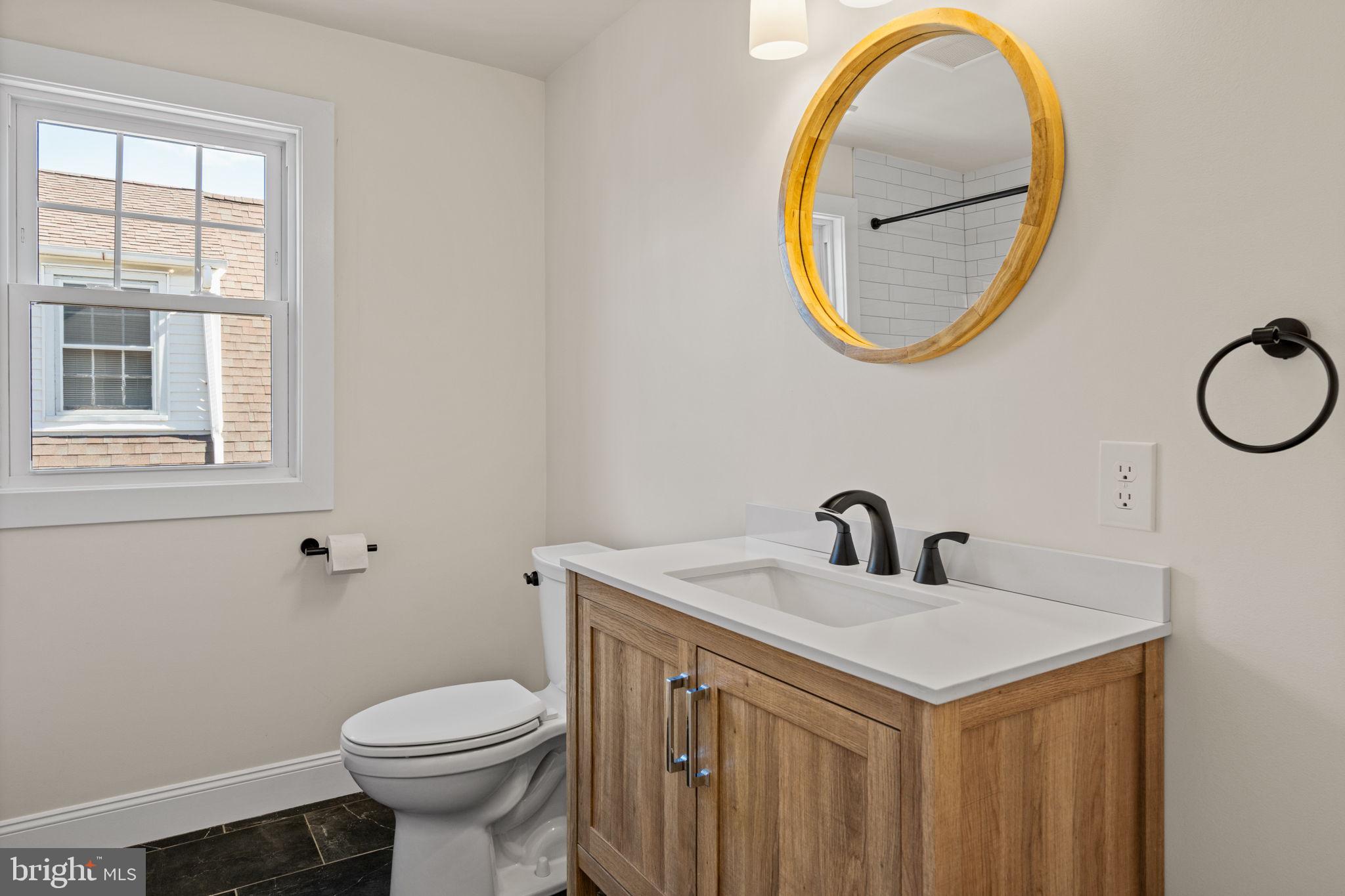 1439 Dorchester Road Havertown, PA 19083 - Photo 43 of 60 a bathroom with a sink mirror and a toilet