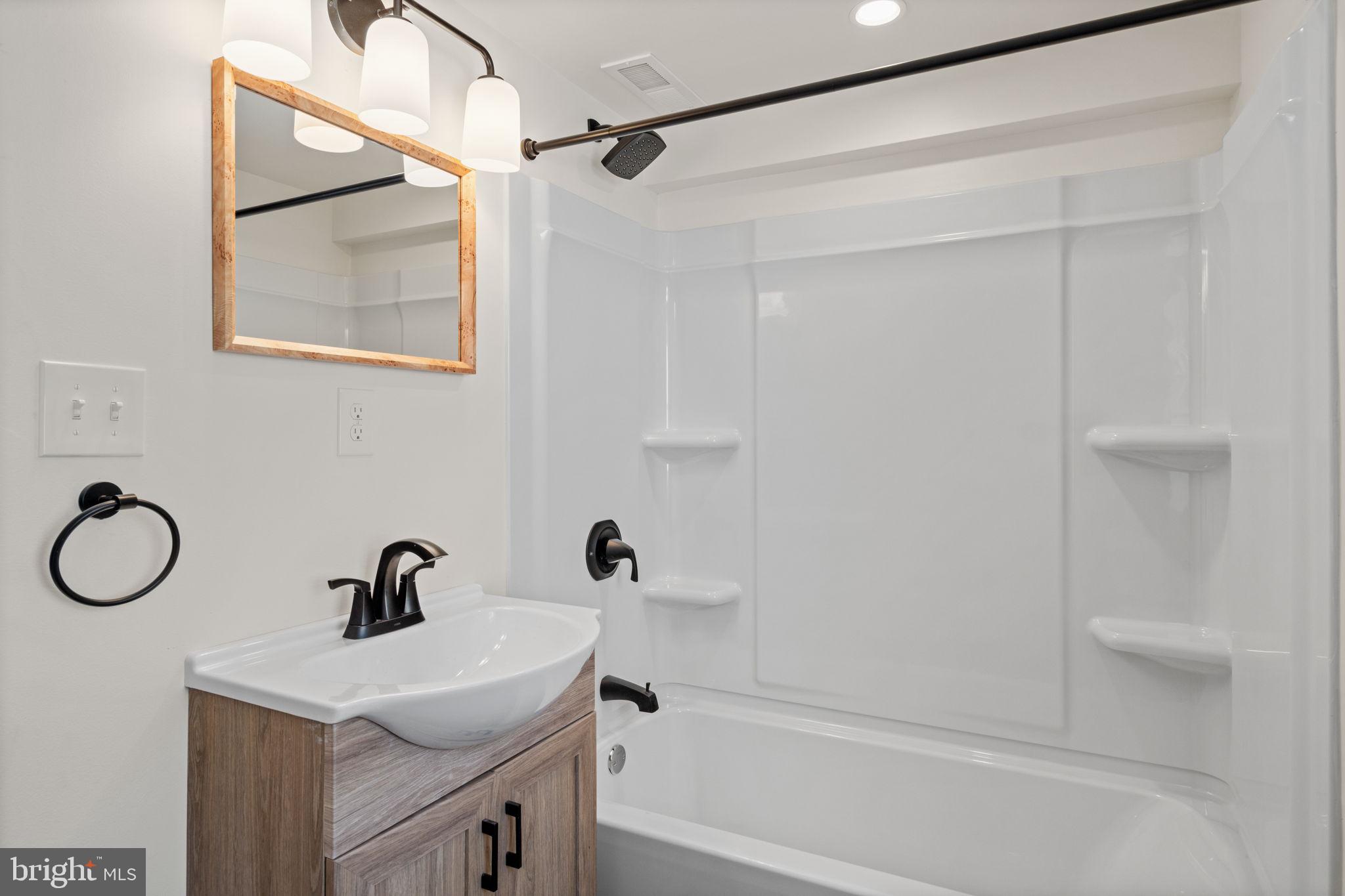 1439 Dorchester Road Havertown, PA 19083 - Photo 49 of 60 a bathroom with a sink a mirror and a shower