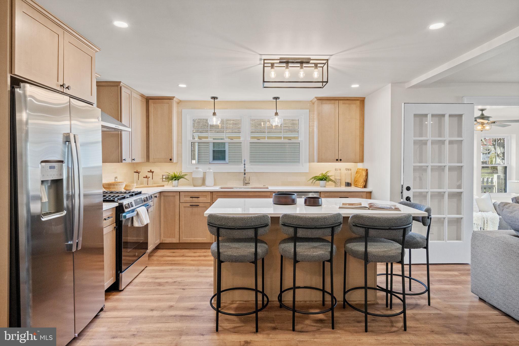 1439 Dorchester Road Havertown, PA 19083 - Photo 10 of 60 a kitchen with stainless steel appliances granite countertop a refrigerator a stove a sink a dining table and chairs
