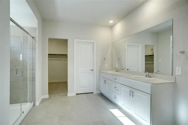 a bathroom with a double vanity sink and mirror