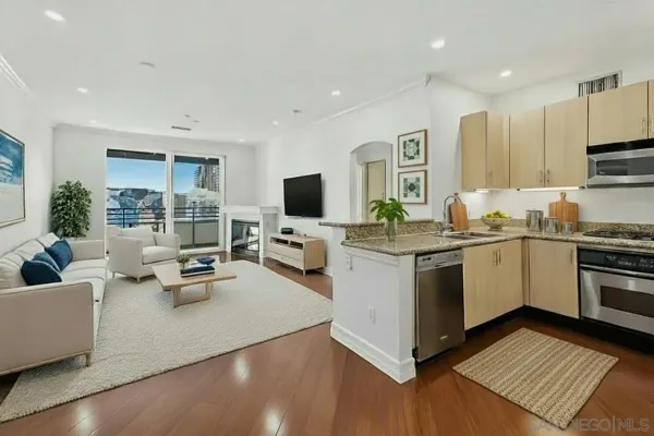 a kitchen that has a sink and a stove top oven