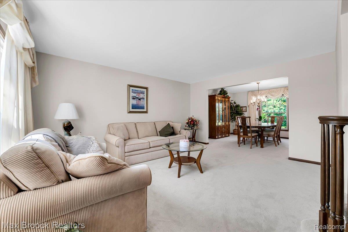 217 Stonetree Circle Rochester, MI 48309 - Photo 5 of 44 Expansive living space with light-toned wall paint and plush carpeting